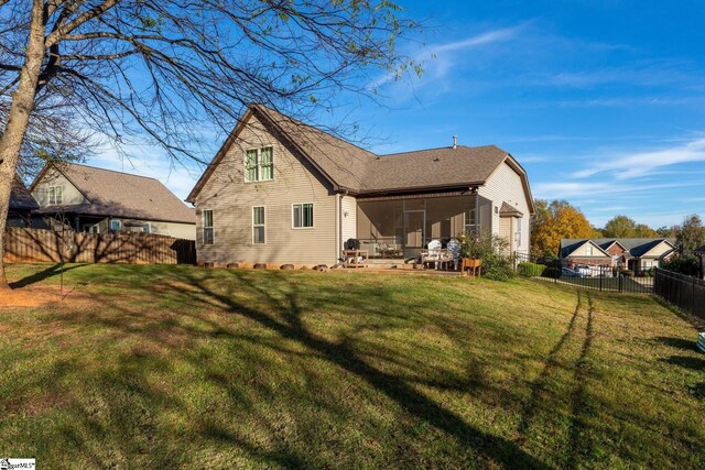 back of house featuring a yard