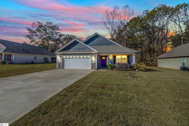 view of front facade with central AC, a yard, and a garage