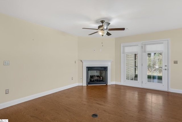 unfurnished living room with hardwood / wood-style floors and ceiling fan