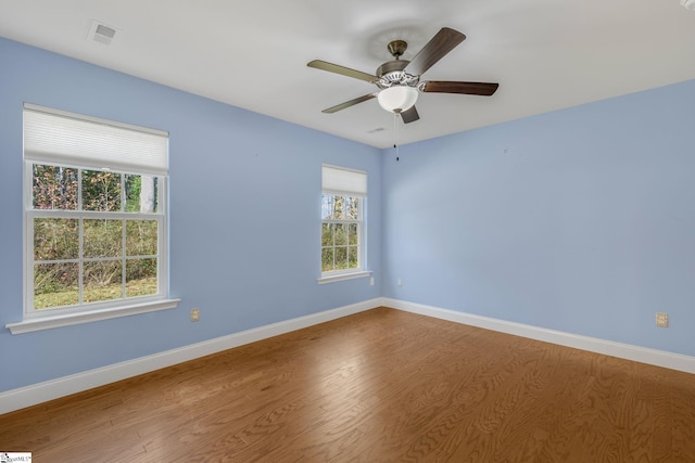 spare room featuring hardwood / wood-style floors, plenty of natural light, and ceiling fan