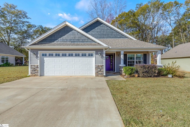 view of front of property featuring a garage and a front lawn