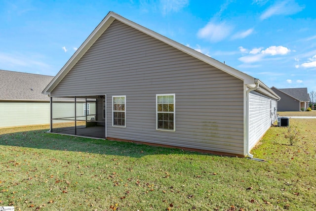 back of property with a lawn, cooling unit, and a patio area