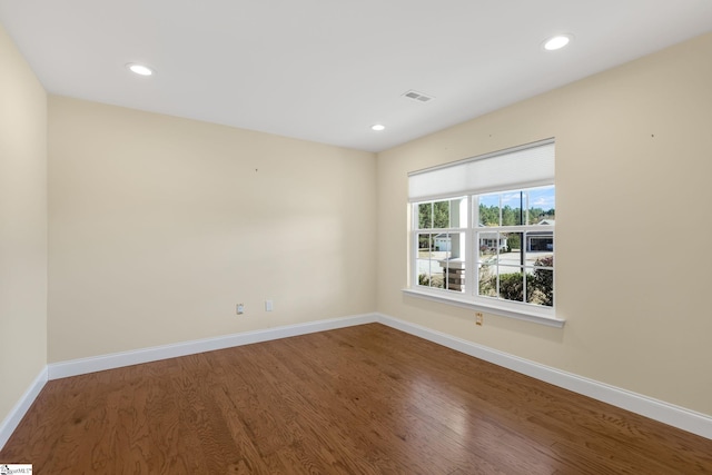 spare room featuring hardwood / wood-style flooring