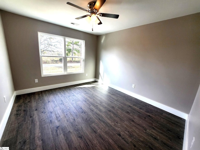 spare room featuring ceiling fan and dark hardwood / wood-style flooring