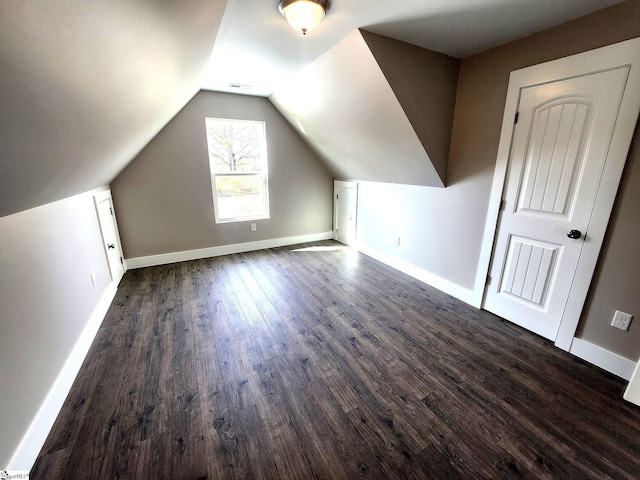 bonus room with dark hardwood / wood-style flooring and lofted ceiling