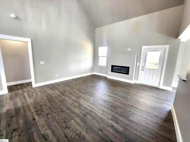 unfurnished living room with dark wood-type flooring and lofted ceiling