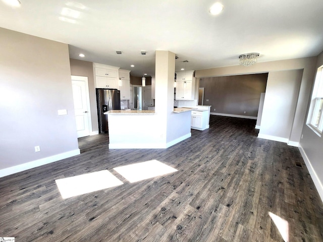 unfurnished living room with dark wood-type flooring