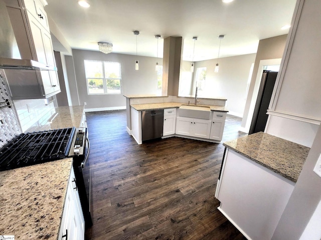 kitchen featuring exhaust hood, sink, decorative light fixtures, dark hardwood / wood-style flooring, and white cabinetry