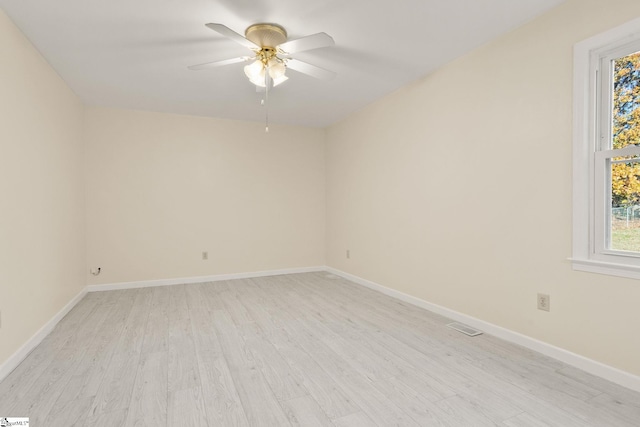 empty room with ceiling fan and light wood-type flooring