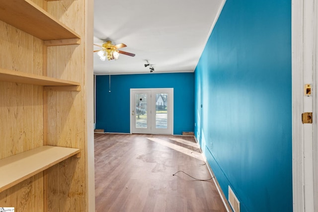 entryway with hardwood / wood-style floors, crown molding, french doors, and ceiling fan