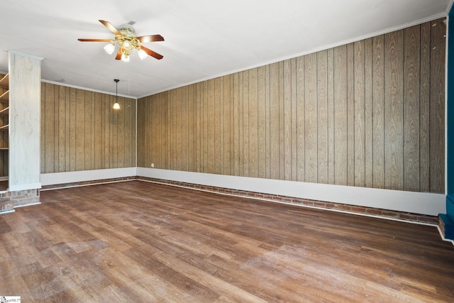 empty room with hardwood / wood-style flooring, ceiling fan, and ornamental molding