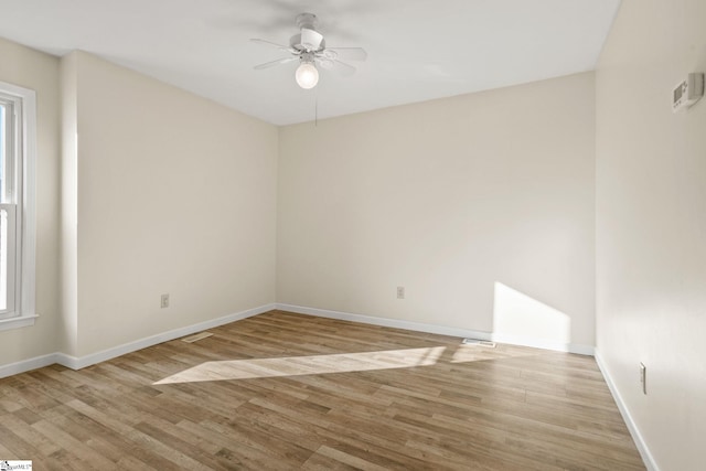 empty room with ceiling fan and light wood-type flooring