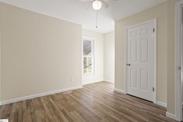 unfurnished bedroom featuring light wood-type flooring and ceiling fan