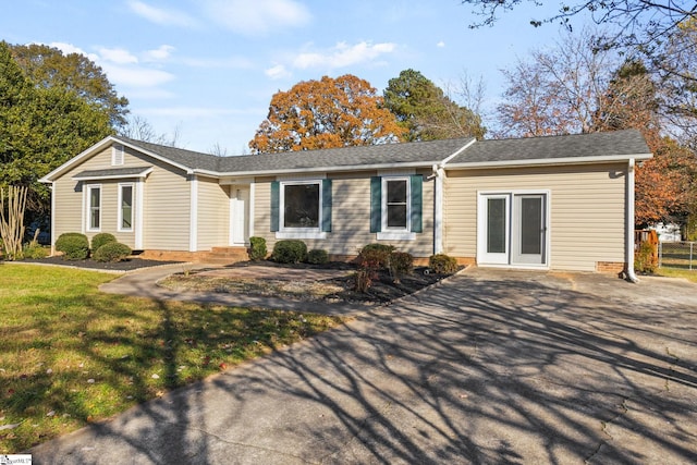 ranch-style home with a front lawn