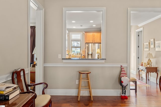 sitting room featuring hardwood / wood-style flooring and crown molding