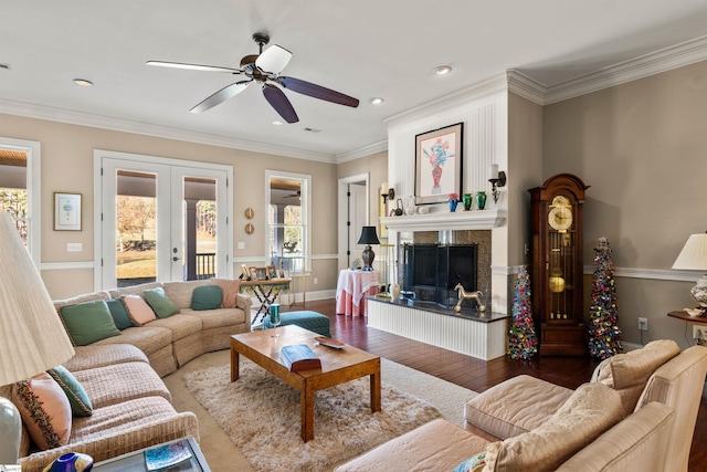 living room featuring ceiling fan, dark hardwood / wood-style flooring, ornamental molding, and french doors