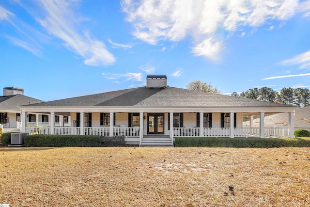 view of front of house featuring a front yard, french doors, and central AC