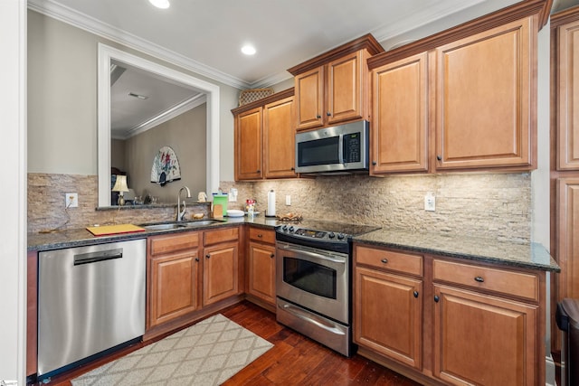 kitchen with decorative backsplash, appliances with stainless steel finishes, dark hardwood / wood-style flooring, ornamental molding, and sink