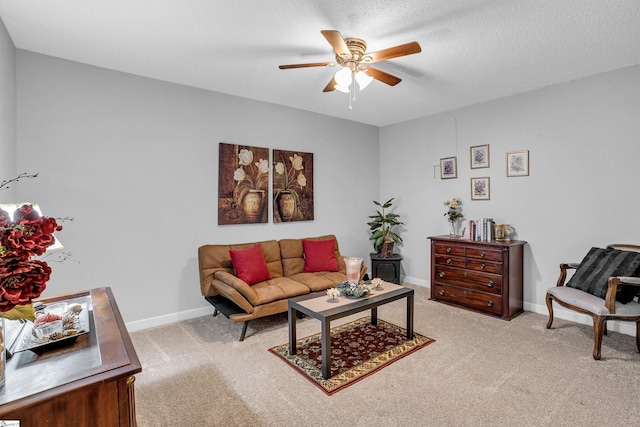 living room with a textured ceiling, light colored carpet, and ceiling fan