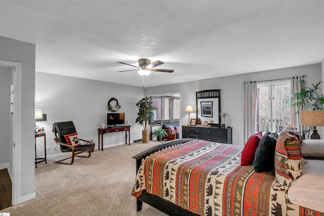 carpeted bedroom with ceiling fan and a textured ceiling