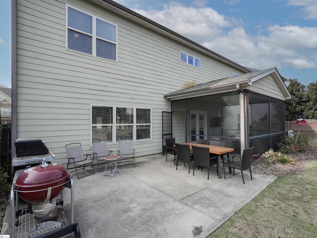 rear view of property with a sunroom and a patio area