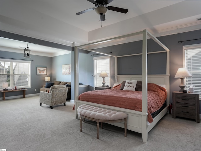 carpeted bedroom with ceiling fan and crown molding