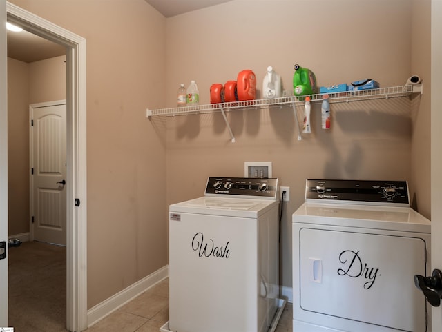 clothes washing area featuring light tile patterned flooring and independent washer and dryer