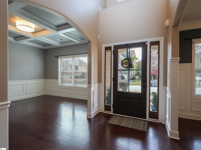 entrance foyer featuring beamed ceiling, dark wood-type flooring, plenty of natural light, and coffered ceiling