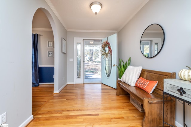 entrance foyer featuring crown molding and light wood-type flooring