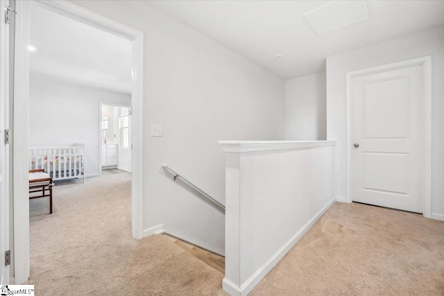 corridor featuring light colored carpet