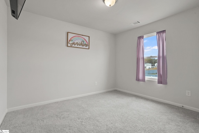 spare room featuring carpet flooring