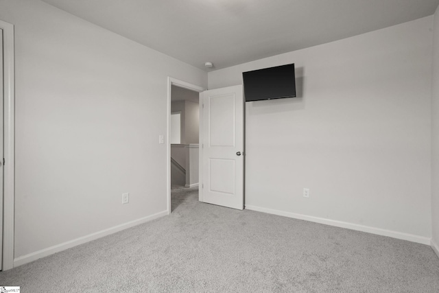 unfurnished bedroom featuring light carpet