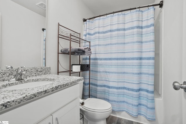 full bathroom with shower / bath combination with curtain, vanity, hardwood / wood-style flooring, and toilet