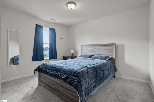 bedroom with light colored carpet