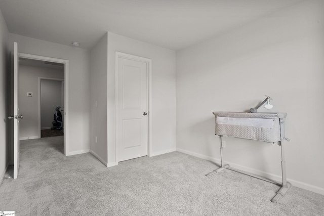 bedroom featuring light colored carpet