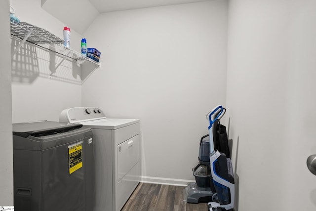 laundry area featuring dark hardwood / wood-style floors and washer and dryer