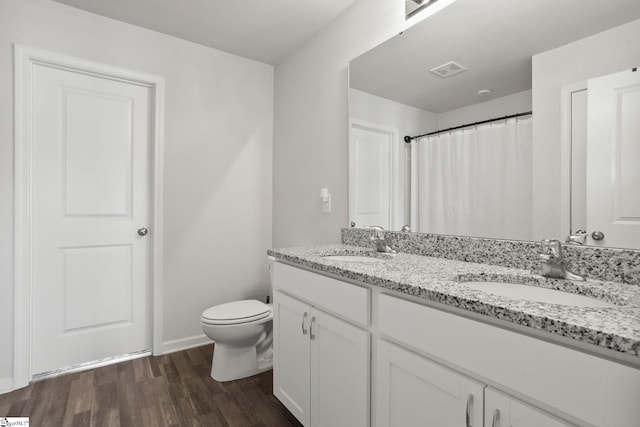 bathroom featuring hardwood / wood-style floors, vanity, and toilet