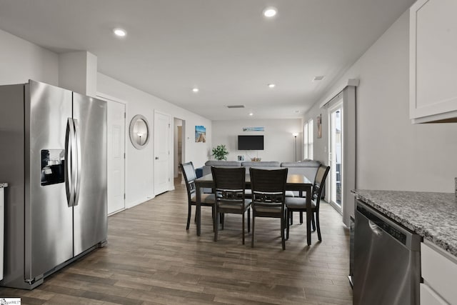 dining space with dark wood-type flooring