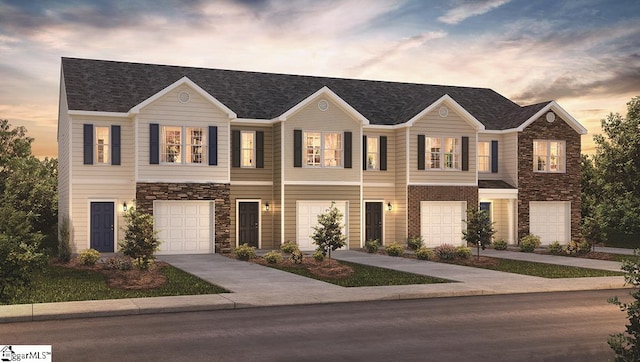 view of front facade featuring a garage, stone siding, and driveway