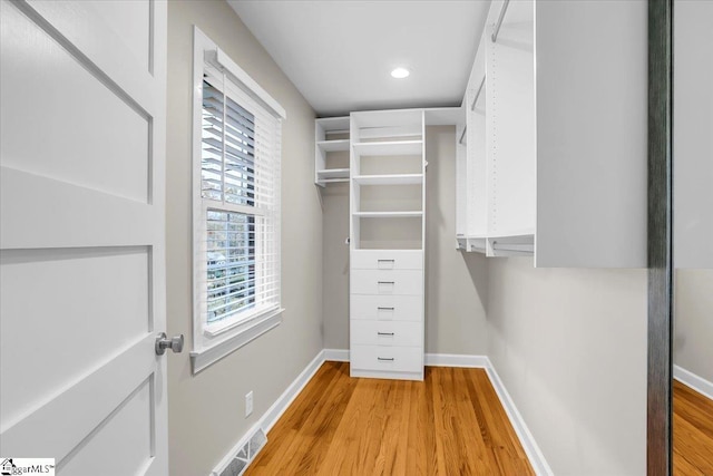 spacious closet with light hardwood / wood-style flooring