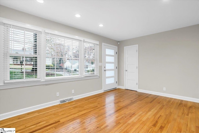 unfurnished room with hardwood / wood-style floors