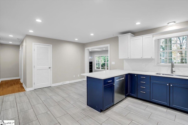 kitchen with dishwasher, kitchen peninsula, a healthy amount of sunlight, and sink