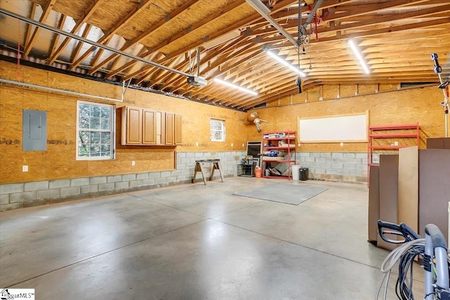 garage with a garage door opener and electric panel