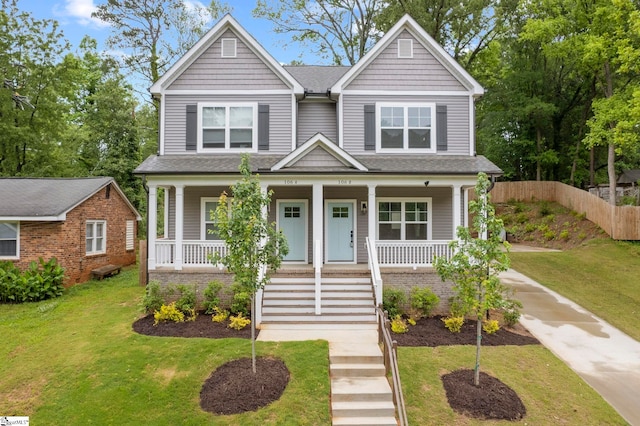 view of front of home with covered porch and a front yard