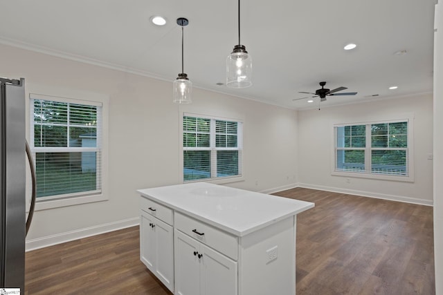 kitchen featuring white cabinetry, stainless steel fridge, a healthy amount of sunlight, and decorative light fixtures