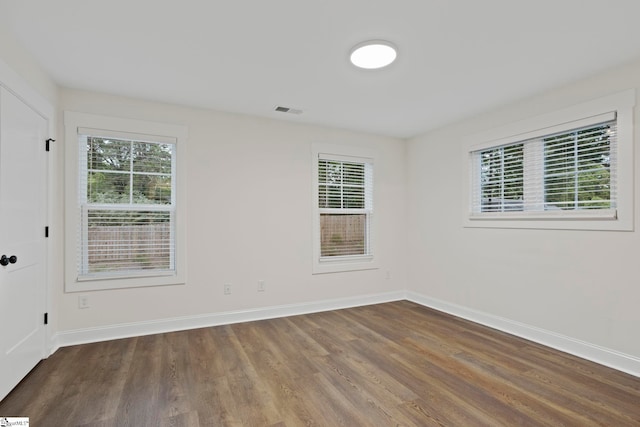 empty room featuring dark hardwood / wood-style flooring