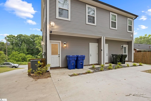 rear view of house with central AC and a patio area