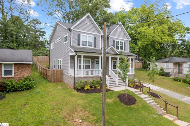 view of front of home with a porch and a front yard