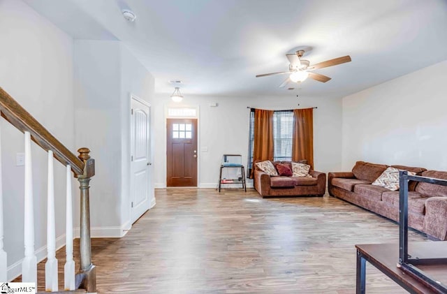 living room featuring ceiling fan and light hardwood / wood-style flooring