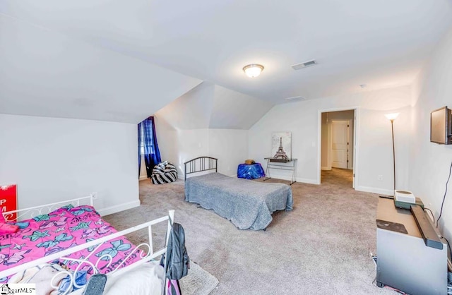 carpeted bedroom with lofted ceiling